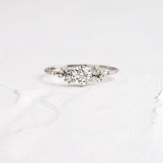 three stone diamond ring on white background