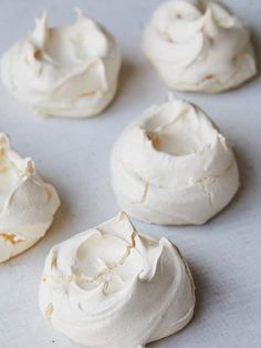 white frosted pastries sitting on top of a baking sheet covered in icing