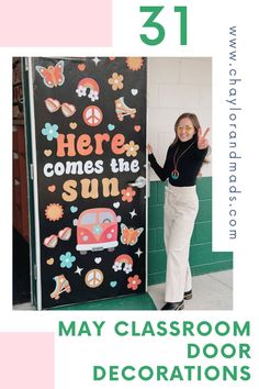 a woman standing next to a sign that says,'may classroom door decorations '