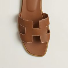 These Hermes Oran Sandals Are A Must-Have For Any Fashionable Woman's Collection. The Vibrant Brown Color Adds A Pop Of Brightness To Any Outfit, While The Comfortable Design Ensures They Can Be Worn For Hours On End. Perfect For Any Occasion, These Sandals Are Sure To Become A Staple In Your Wardrobe. Crafted With The Highest Quality Materials, These Sandals Are Both Durable And Stylish. The Iconic Hermes Brand Adds A Touch Of Luxury To Any Outfit, And The Unique Design Of The Oran Model Makes Hermes Oran Sandals, Hermes Style, Hermes Oran, Hermes Shoes, Balenciaga Designer, Brown Sandals, Shoe Brands, Brown Color, Women Collection