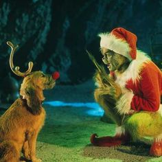 a dog and santa clause sitting next to each other