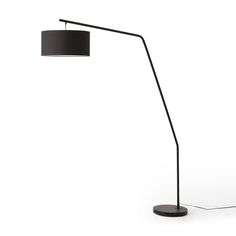 a floor lamp with a black shade on the base and a white light behind it