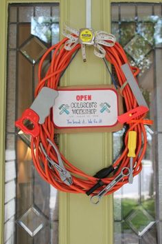 an orange cord is attached to the front door with scissors and wires on it,