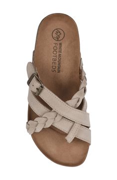 Traditional buckle slide Harrington leather sandal by White Mountain Footbeds(TM) with braided straps over the top of the foot is a new addition to your easy summer style. Featuring our signature molded suedette footbed with comfort heel cup, this sandal is a great everyday summer style.Sizing: True to size. M=standard width . Toe loop. Leather upper. Buckled strap detail. Slip-on. Contoured footbed. Mule back. Imported  This item cannot be shipped to Canada. Leather upper, synthetic sole Casual Beige Braided Sandals, Beige Suede Sandals With Woven Sole, Suede Slides With Buckle Closure For Beach, Comfortable Braided Sandals, Casual Adjustable Toe Loop Slides, Casual Adjustable Suede Slides, Casual Braided Leather Sandals, Casual Sandals With Braided Straps And Single Toe Strap, Comfortable Slip-on Sandals With Braided Straps