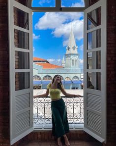 a woman is standing in an open doorway