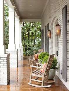 two rocking chairs sitting on the front porch