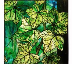 a stained glass window with green leaves on it