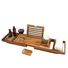 a wooden tray with bottles and glasses on it