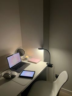 a laptop computer sitting on top of a white desk