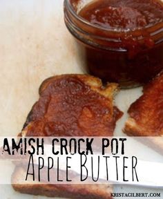 two pieces of bread sitting on top of a cutting board next to a jar of apple butter