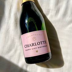 a bottle of champagne sitting on top of a bed