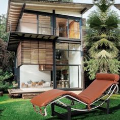 a chaise lounge in front of a modern house