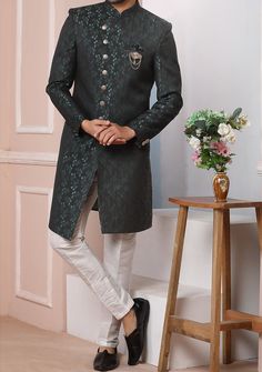 Ready-Made Sherwani With Trouser. Jacquard Brocade Fabric Top. Art Dupion Aligarhi Ready Made Trouser. Crafted in Chinese Collar Neck, and Full Sleeve. Satin Lining with Plain Work. High-Quality Matching Buttons. Please Note: The footwear shown in the picture is for presentation and photography purpose only. Color: There might be slight color variation due to lightings and flashes while photo shooting. The color may also vary because of different screen resolutions. Wash Care: Dry Clean Only. Formal Green Churidar With Dabka Detailing, Ceremonial Jamawar Kurta With Cutdana Details, Ceremonial Jamawar Kurta With Cutdana, Semi-stitched Long Sets For Formal Occasions, Formal Long Semi-stitched Sets, Suits With Zari Work In Traditional Drape, Formal Art Silk Salwar Kameez With Dabka Detail, Formal Salwar Kameez In Art Silk With Dabka Details, Formal Art Silk Salwar Kameez For Eid