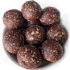 a white bowl filled with chocolate balls on top of a table