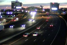 traffic is backed up on the freeway at night in this time lapse photo from an overpass