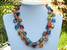 "3 Strand Necklace, Murano Glass, \"Exposed Gold\" Venetian Beads, Small Flat Squares with 24 Karat Gold Foil, Multicolored Lampworked Beads; handmade beads from Venice, Italy. This outstanding triple strand necklace is shown here in a vivid display. A beautiful necklace to go with every color in your wardrobe! The colorful, Venetian glass beads are handcrafted in such a way, as to show, or \"Expose\" the 24 karat gold foil. That is why I originated the term, \"Exposed Gold\" when referring to t Elegant Multicolor Beaded Necklaces With Spacer Beads, Elegant Multicolor Beaded Necklaces With Large Beads, Elegant Multicolor Beaded Necklace With Large Beads, Multicolor Czech Glass Beads For Party, Elegant Multicolor Glass Beaded Necklaces, Elegant Multicolor Czech Glass Necklaces, Elegant Multicolor Beaded Gems And Cabochons, Elegant Multicolor Large Beads Gems And Cabochons, Elegant Multicolor Glass Beaded Necklace