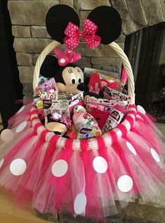 a minnie mouse basket with candy, candies and other items in it sitting on a table