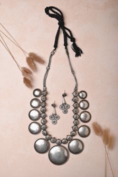 Channel your inner queen with this stunning long necklace, perfect for making a royal statement! Complete the look with matching silver jhumkas that add the right touch of boho chic. Whether you're dressing up for a big event or just want to feel fabulous, this set is your go-to for instant glam! The penny is kept aside to make you understand the real size of the object. Elegant Silver Jewelry Sets For Navratri, Bohemian Jewelry Sets For Diwali Party, Silver Bohemian Bridal Necklace, Bohemian Style Bridal Necklace For Festive Occasions, Bohemian Style Bridal Necklace, Silver Jewelry For Navratri Party, Festive Bohemian Temple Necklace, Silver Long Necklace For Festivals, Silver Long Necklace For Diwali