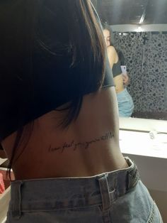 the back of a woman's neck with writing on it