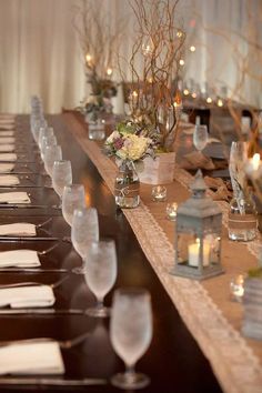 a long table is set up with candles and place settings for the guests to sit at