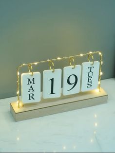 a wooden stand with three calendars on it that read mar 19 and the number nineteen