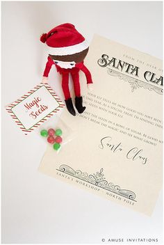 a stuffed animal is next to a santa clause letter