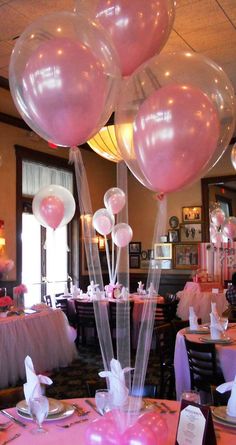 pink balloons are in the air at a party