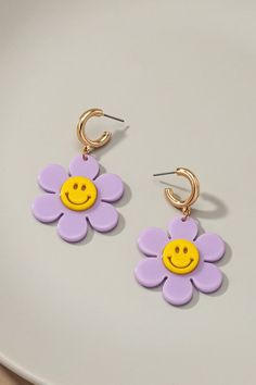 Huggie hoop dangling flower earrings with smiley face center in bright colors. Made of acrylic and base metal.Size: 1.5" x 2.0" Flower Smiley Face, Smiley Face Earrings, Flower Smiley, Clay Inspo, Face Earrings, Acrylic Jewellery, Fashion Jewelry Earrings, Huggie Hoop Earrings, Acrylic Earrings