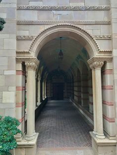 an archway leading into a building with columns