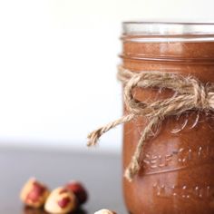 a jar filled with nuts sitting on top of a table