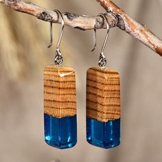 Modern trends merge with the magical aura of the Armenian forests in this geometric design made for those with a mystic soul. Artisan Kamo Galstyan uses apricot wood to create these dangle earrings, whose rectangular shape gracefully includes blue resin accents as a symbol of fantasy and imagination. The pieces also have sterling silver hooks for a glorious display of beauty. Mystic Soul, Wood Resin Jewelry, Wood And Resin, Mens Jewelry Necklace, Wood Earrings, Modern Earrings, Geometric Earrings, Jewelry Packaging, Hook Earrings