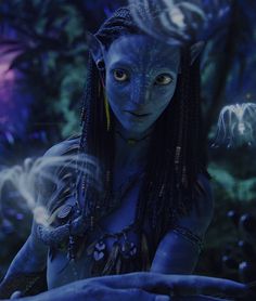 a woman with blue makeup and braids in the woods