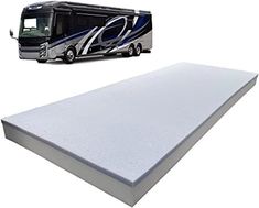 an rv parked next to a mattress on a white background with a black and blue bus in the background