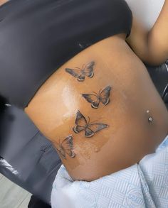 a woman's stomach with butterflies on it