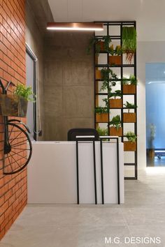 a bike is parked in front of a brick wall with plants growing on the shelves