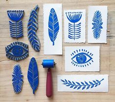 some blue and white paper cut outs on a wooden table