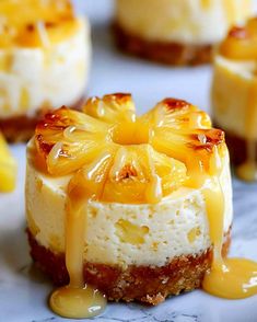 several small desserts with pineapple topping on them