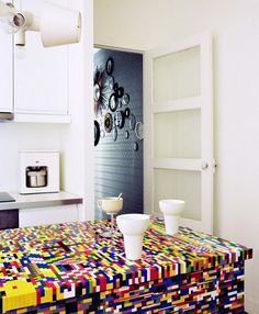 a multicolored table in a white kitchen