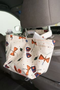 a bag hanging from the back seat of a car