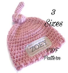 a pink crocheted hat with the word zofy written in white on it