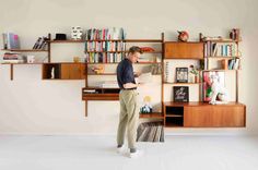 a man standing in front of a book shelf