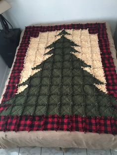 a quilted christmas tree sitting on top of a bed