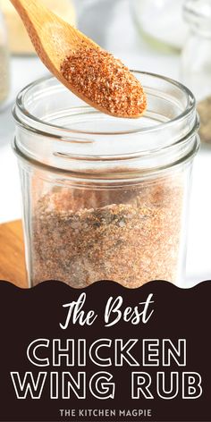 the best chicken wing rub recipe in a glass jar with a wooden spoon on top