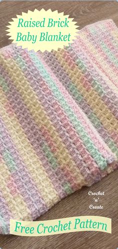 a crocheted baby blanket sitting on top of a wooden floor with the title raised brick baby blanket free crochet pattern