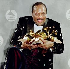 a man holding two awards in his hands