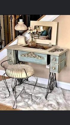 an antique dressing table with mirror and stool in front of the stair case is shown