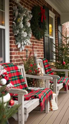 the porch is decorated for christmas with red and green plaid