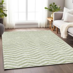 a living room area with a white couch and green rug on the hardwood flooring