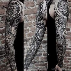 the back of a man's arm with tattoos on it and an intricate design