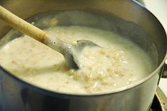 a wooden spoon in a pot filled with food